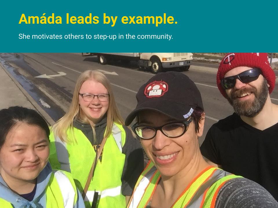Amáda leads by example. She motivates others to step-up in the community. Shown here leading volunteers in a street cleanup.