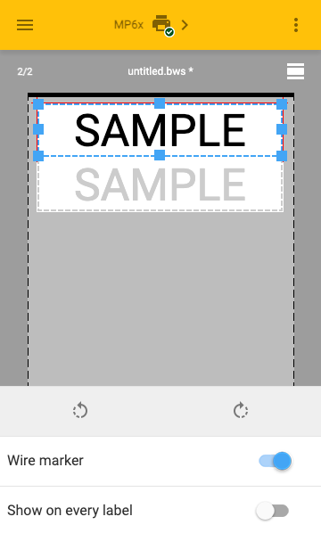 A label editor concept, showing the word SAMPLE repeated twice on a label. A property sheet across the bottom has a few controls, one of which is a toggle switch titled Wire Marker.